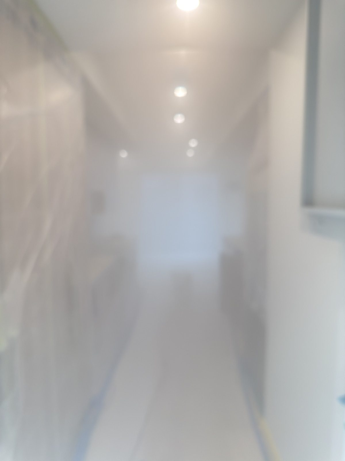 AeroBarrier sealant mist filling the upstairs hallway of a finished townhome unit during the seal